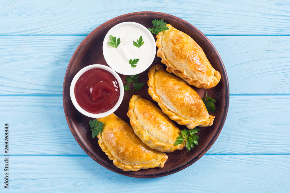 Latin American baked beef empanadas with sauce Latin American baked beef empanadas with sauce