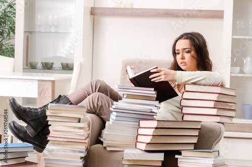 Young female student preparing for exams at home 