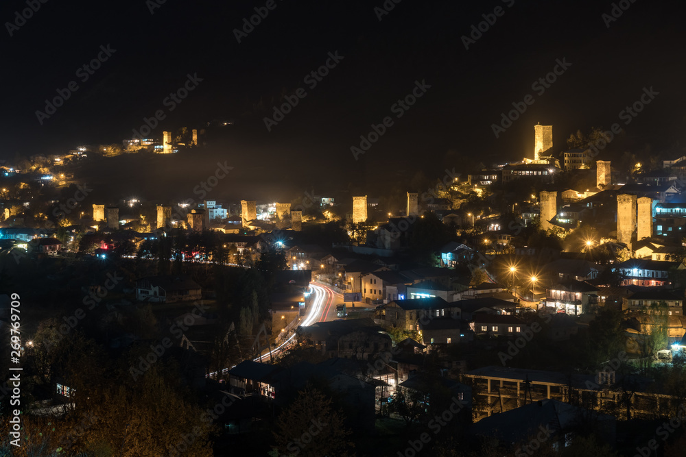 View of Svan towers with night illumination in Mestia village at night. Svaneti, Georgia