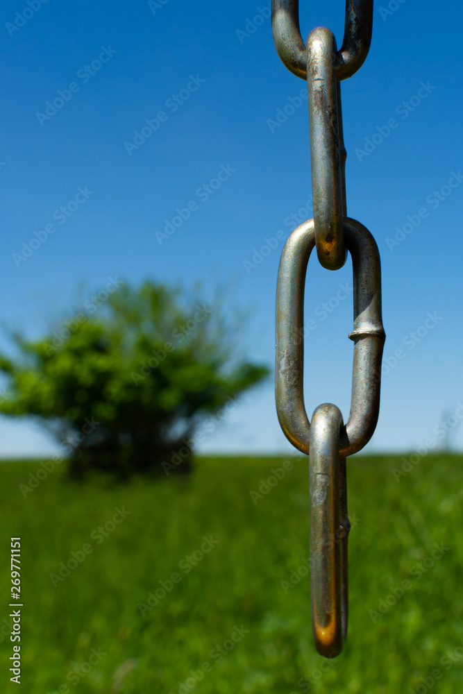 Chain with field in background Chain with field in background