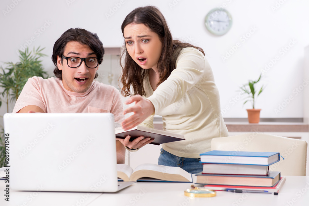 Students preparing for exam together at home Students preparing for exam together at home