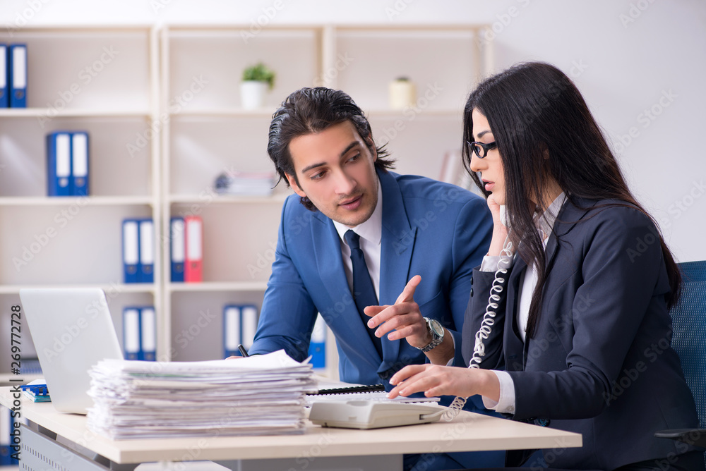 Two employees working in the office Two employees working in the office