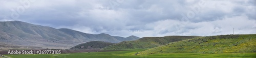 Landscape stormy panorama view from the border of Utah and Idaho from Interstate 84, I-84, view of rural farming with sheep and cow grazing land in the Rocky Mountains. United States. © Jeremy