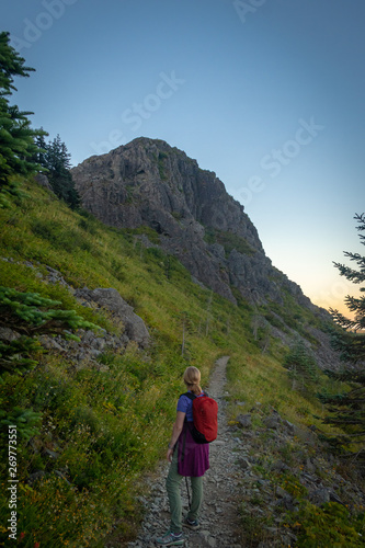 Hiker Looking at Mountain in Distance on Trail