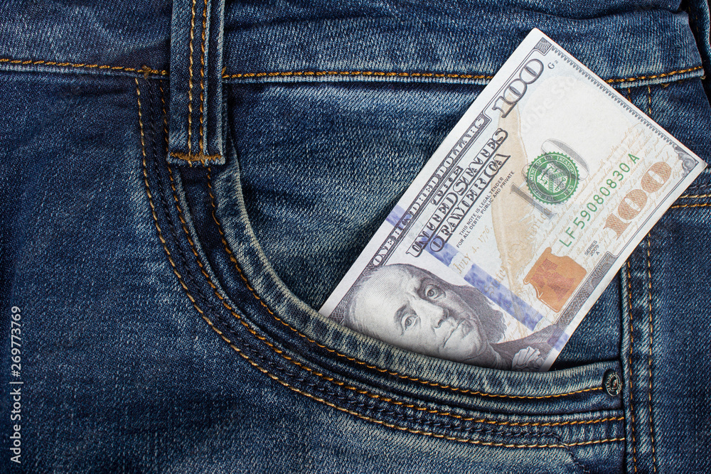Jeans pants with dollar bill in pocket close up. Jeans pants with dollar bill in pocket close up.