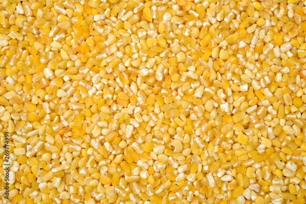 raw crushed corn groats close up raw crushed corn groats close up