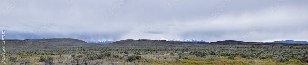 Sawtooth Mountains National Forest Landscape stormy panorama from South headed to Sun Valley, view of rural grazing land, Sagebrush, Lava Fields in Idaho. United States.