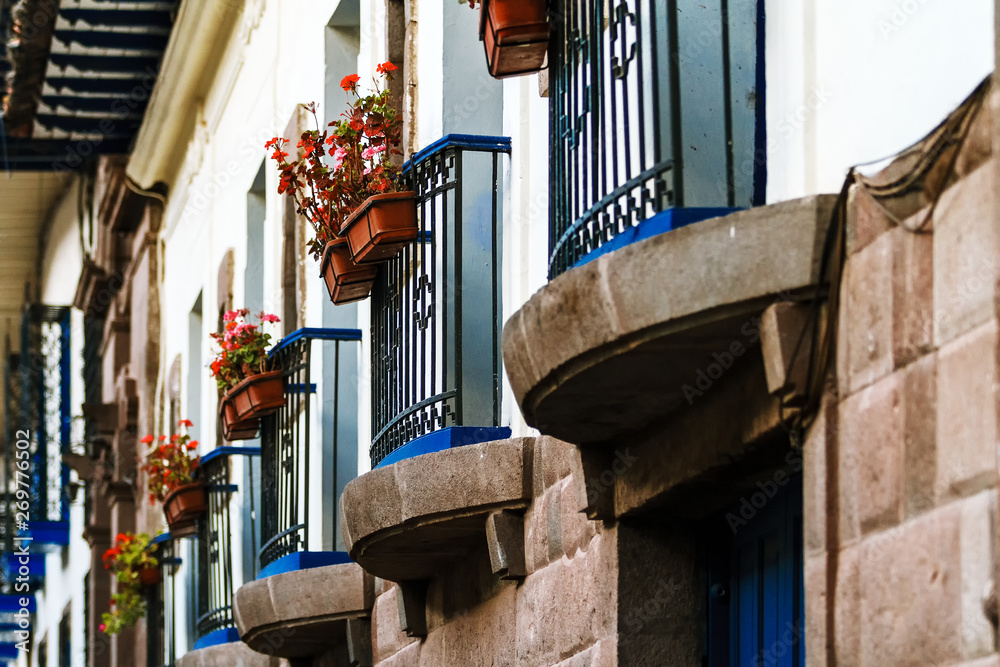 Blue balconies with plants and flowers in a colonial building in Cusco, Peru Blue balconies with plants and flowers in a colonial building in Cusco, Peru