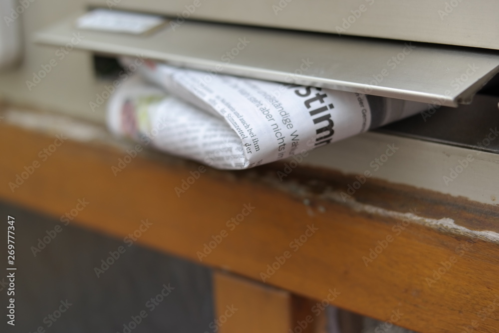 a newspaper in the mailbox a newspaper in the mailbox