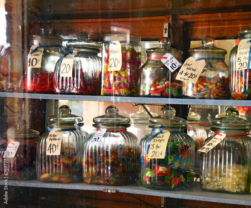 Candy lolly jars of glass and price tages look sweet and traditional in small country town shop.