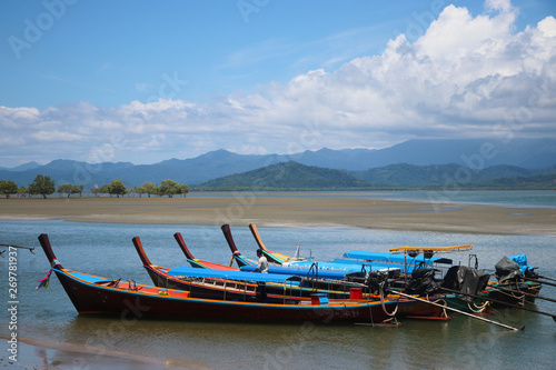 Wooden boats on beach landscape with sky and mountian background