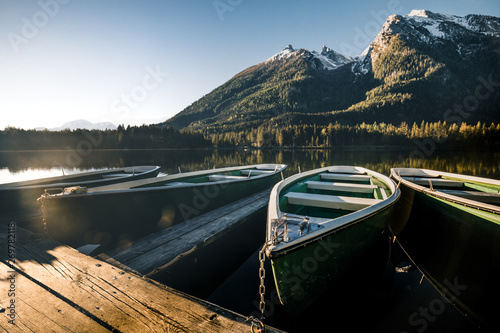 Colorful summer sunrise on the Hintersee lake with white pleasure launches. photo