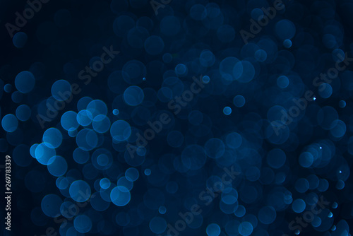 Glitter lights abstract dark blue background. Defocused bokeh dark illustration
