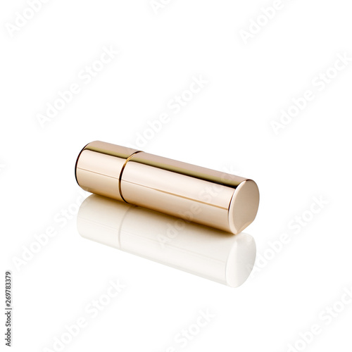 Lipstick in golden tube on white background with mirror reflection on glass surface isolated closeup  shiny gold lipstick package  closed lipstick box  expensive luxury cosmetic accessory  studio shot