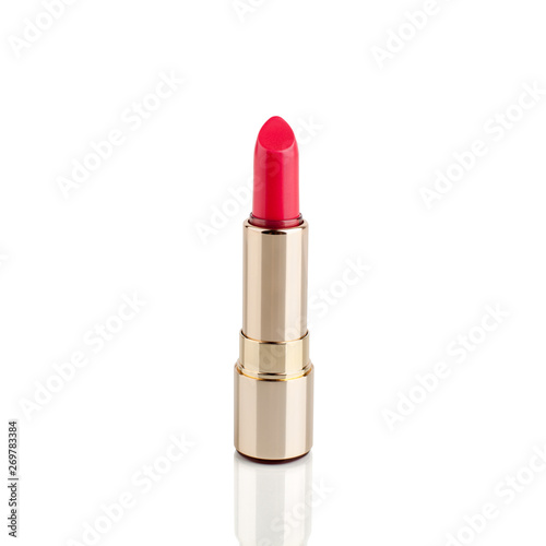 One red lipstick in golden tube on white background with mirror reflection on glass surface isolated close up, open pink lipstick in gold package, luxury cosmetic accessory, studio shot