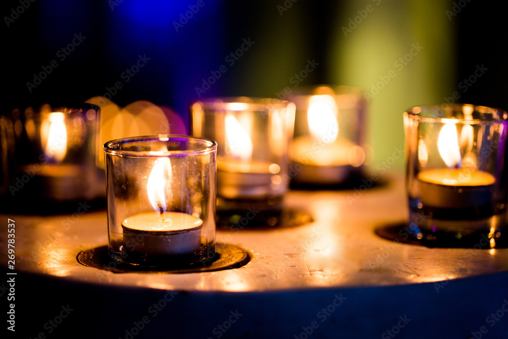 Flame of many candles burning on purple blurred background. Flame of many candles burning on purple blurred background.