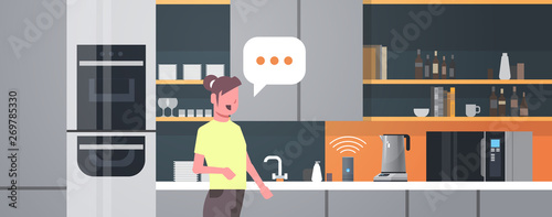 housewife using smart speaker voice recognition activated digital assistants automated command report concept modern kitchen interior flat horizontal portrait