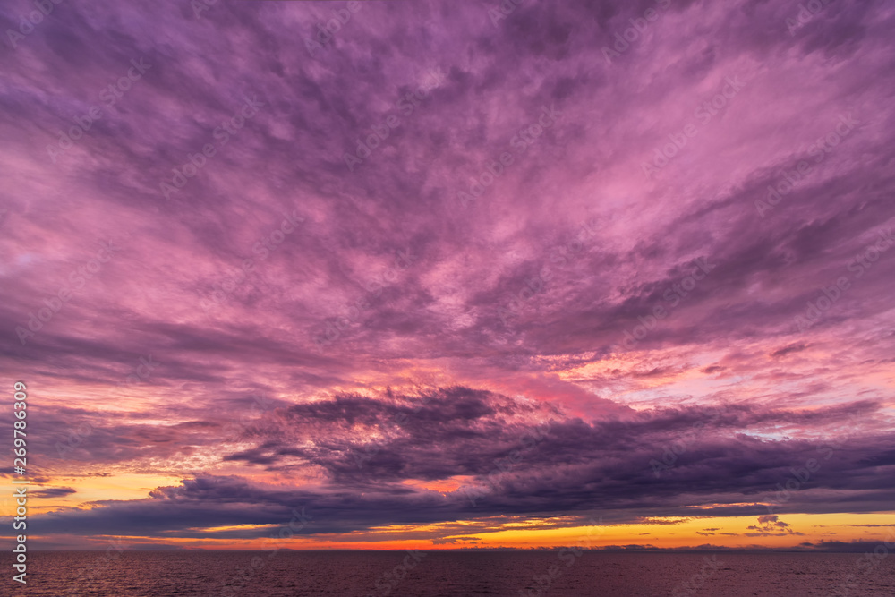 Fototapeta premium Colorful sunset sky. Fiery powerful sunset. Moody colorful sunset. Sunset over a lake.