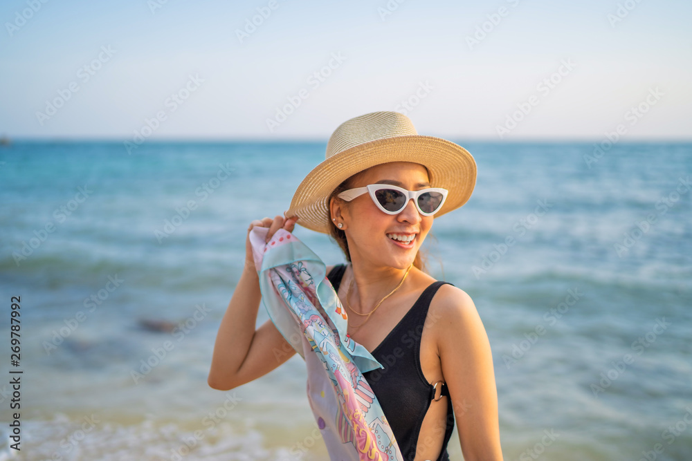 relaxing time concept with traveler girl posing smile in the sea beach in sunset time by wear sunglass and hat relaxing time concept with traveler girl posing smile in the sea beach in sunset time by wear sunglass and hat