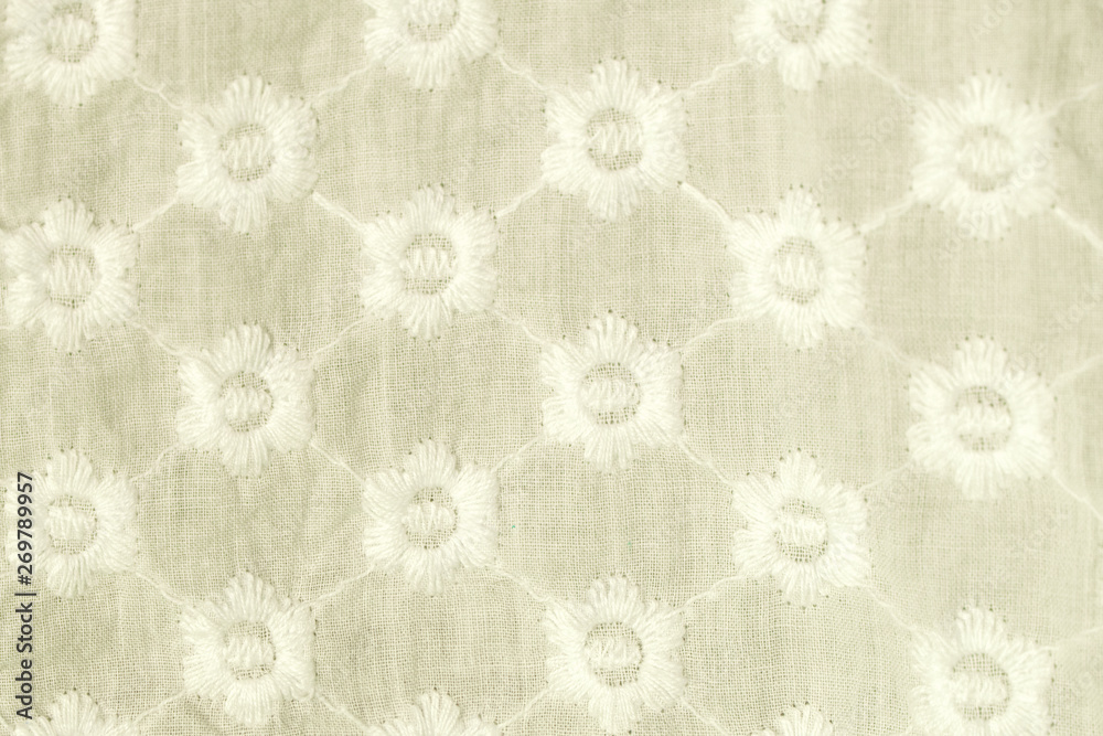 Obraz premium Embroidered blue flowers on a white background.
