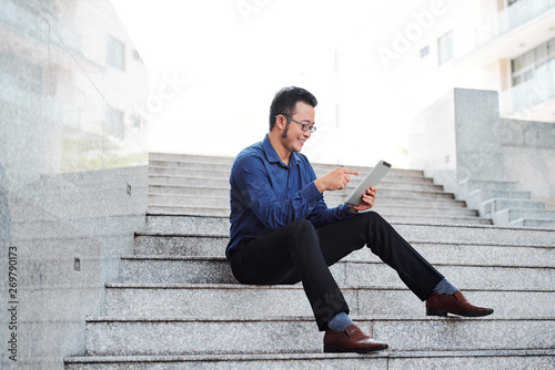 Cheerful entrepreneur with tablet computer © DragonImages