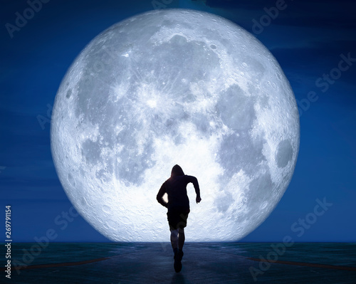 Fototapeta Naklejka Na Ścianę i Meble -  sports background. runner is running on road street to the moon , Soar to the front with speed, concept, exercise and intention, trying for success.Elements of this image furnished by NASA
