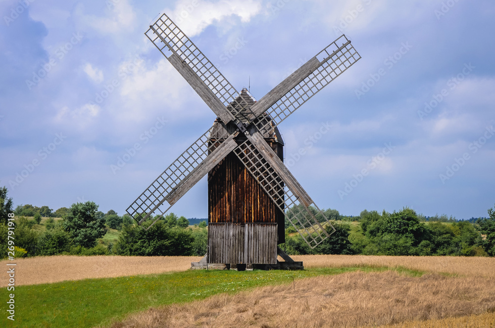 18th century post mill on a field in Poland