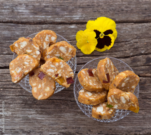 Slices of baked sweets from shortbread dough with caramel and nuts homemade