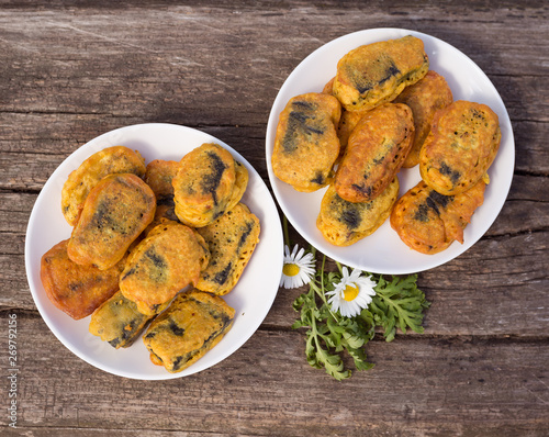 plate with breaded nuggets on the wood background isolated