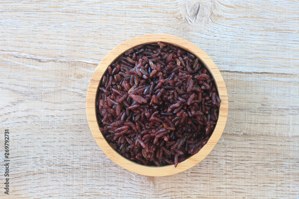 Rice berry in wooden bowl on table. Rice berry in wooden bowl on table.