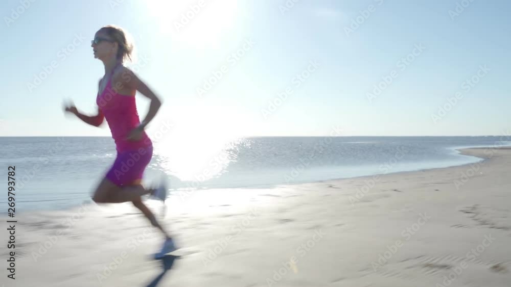independent young woman athlete running on beach exercising female runner sprinting training in sunny seaside background independent young woman athlete running on beach exercising female runner sprinting training in sunny seaside background