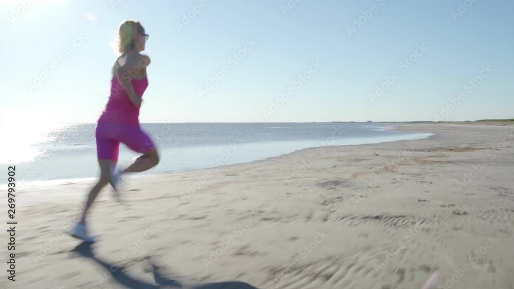 independent young woman athlete running on beach exercising female runner sprinting training in sunny seaside background independent young woman athlete running on beach exercising female runner sprinting training in sunny seaside background