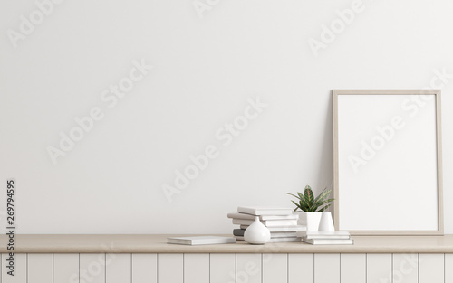 Fototapeta Naklejka Na Ścianę i Meble -  Mock-up of picture frame with small plant in vase and books on white wall. Perspective of modern Interior design. 3d rendering.