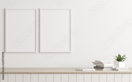 Fototapeta Naklejka Na Ścianę i Meble -  Mock-up of picture frame with small plant in vase and books on white wall. Perspective of modern Interior design. 3d rendering.
