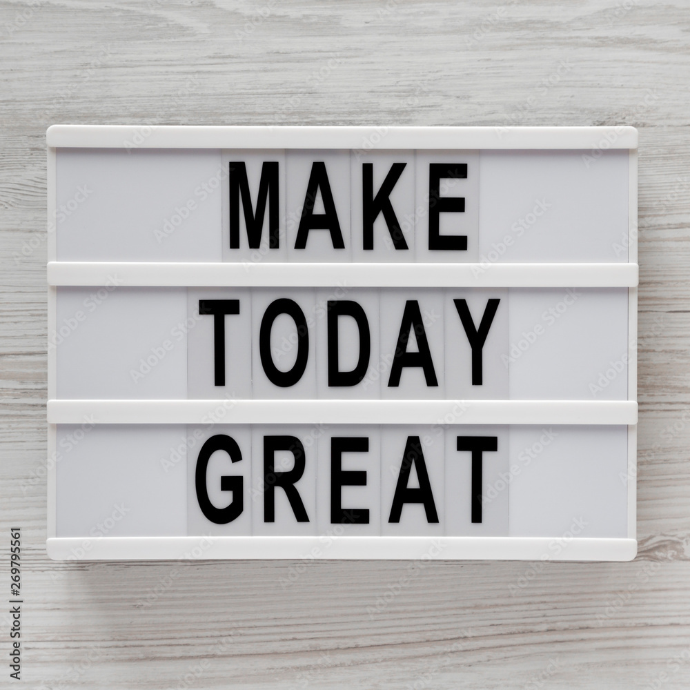 'Make today great' words on a modern board over white wooden surface, top view. Overhead, from above. Flat lay. 'Make today great' words on a modern board over white wooden surface, top view. Overhead, from above. Flat lay.