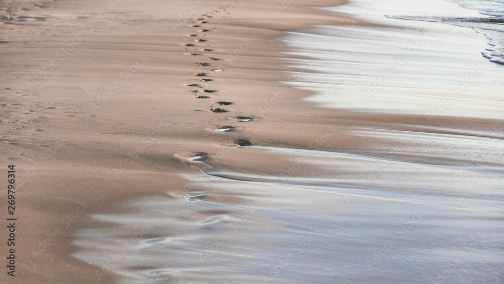 footprints in the sand from the feet of a lost person. no way out of the situation. return to the be