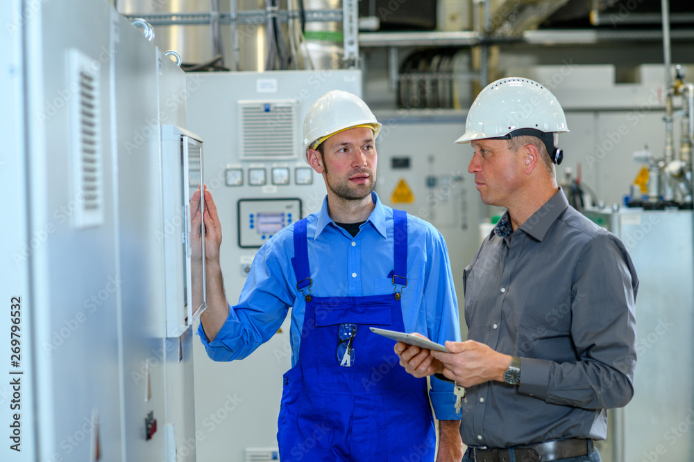 boss with worker in factory boss with worker in factory
