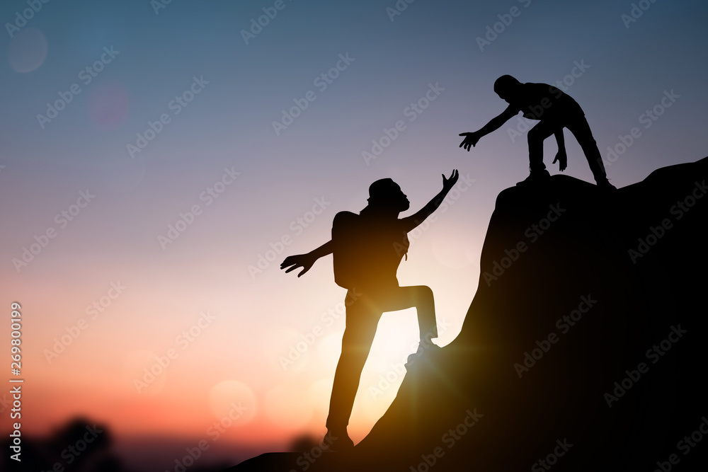 help and improve concept, silhouette people helping other hiker climbing rock and mountain