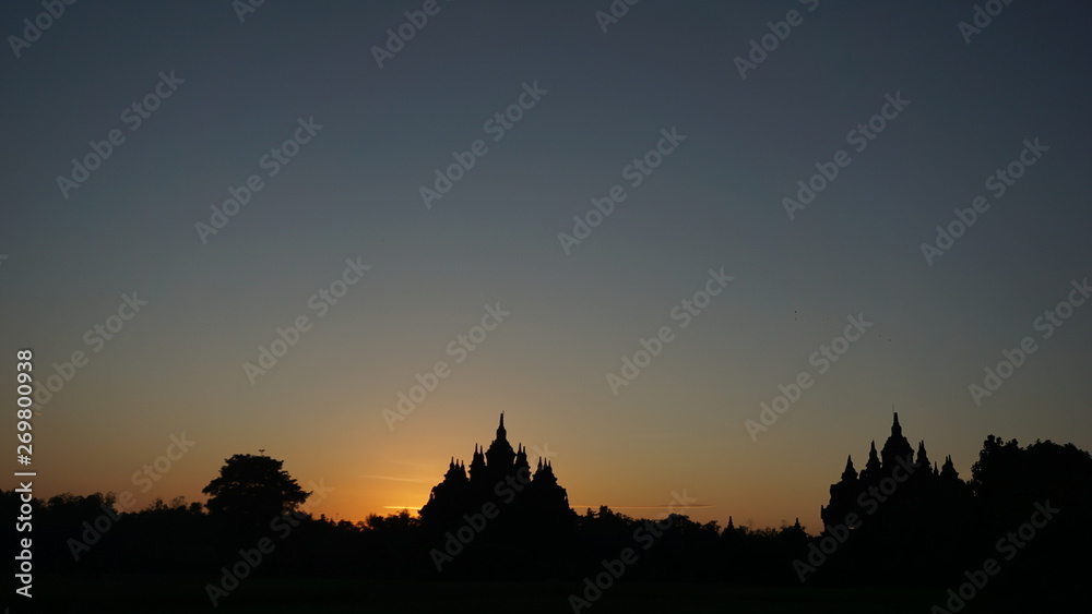 the beginning of summer when the sun rises with the foreground of a temple that looks very beautiful