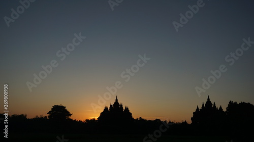 the beginning of summer when the sun rises with the foreground of a temple that looks very beautiful