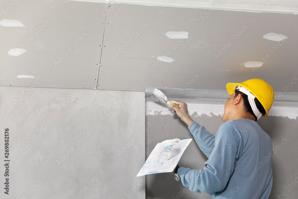 Craftsman working with plaster gypsum ceiling for interior build gypsum