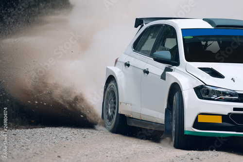 Rally car in motion with the clouds of dust