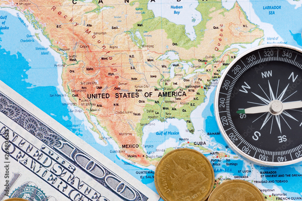 Financial Concept : US Dollar Coin and Compass on America Map Background.