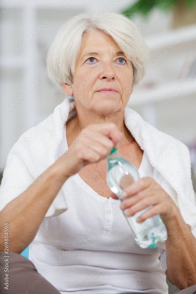 senior woman exercise at home health care drinking water process senior woman exercise at home health care drinking water process