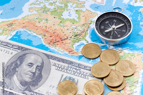 Financial Concept : US Dollar Coin and Compass on America Map Background.