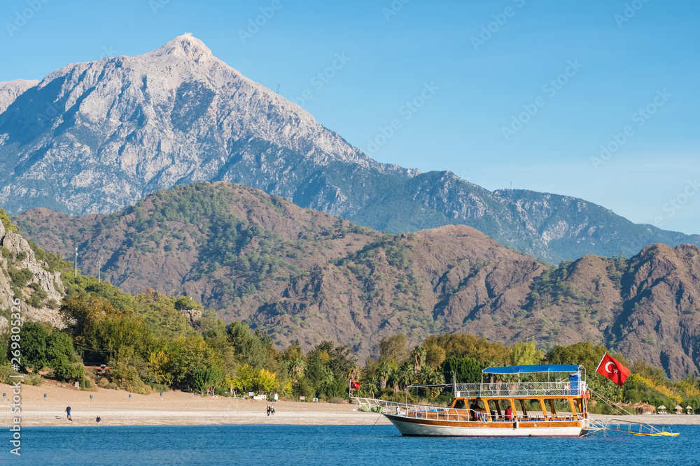 Traditional Turkish ship Gulet in Cirali bay with Tahtali mountain at background in Turkey 