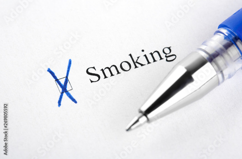 Smoking. Filling in the questionnaire, documents. The checkboxes are filled with a black pen on a white background. Questionnaire, survey.