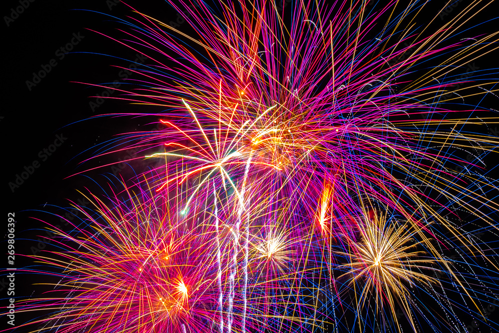 Obraz premium background of multi-colored salute and fireworks closeup on a black background