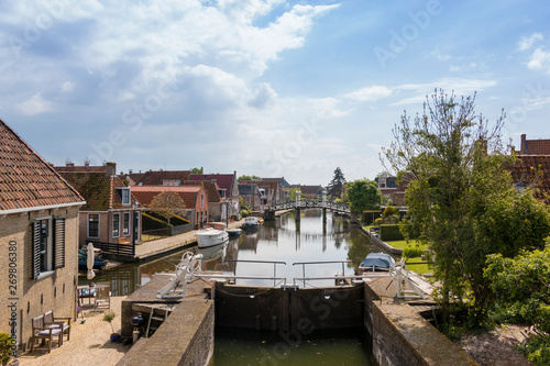 A canal with lock in a historical city in the lake side district of the Netherlands.
