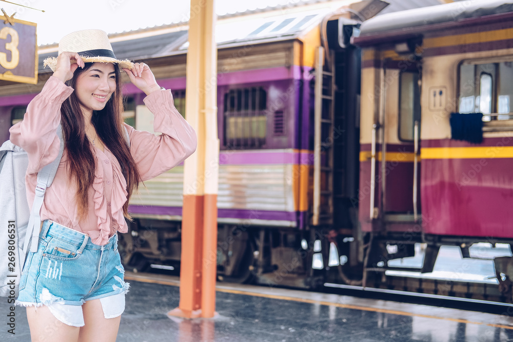 woman  backpacker traveler with backpack at train station. journey trip travel concept